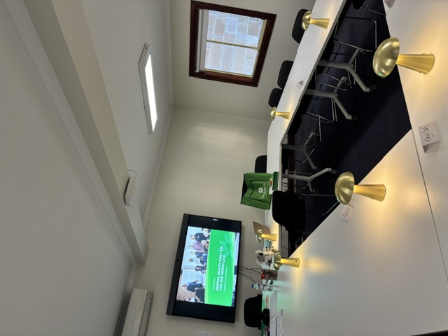 Workplace MHFA training room with screen showing welcome slide