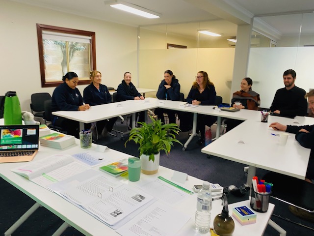 Workplace MHFA training session around a table